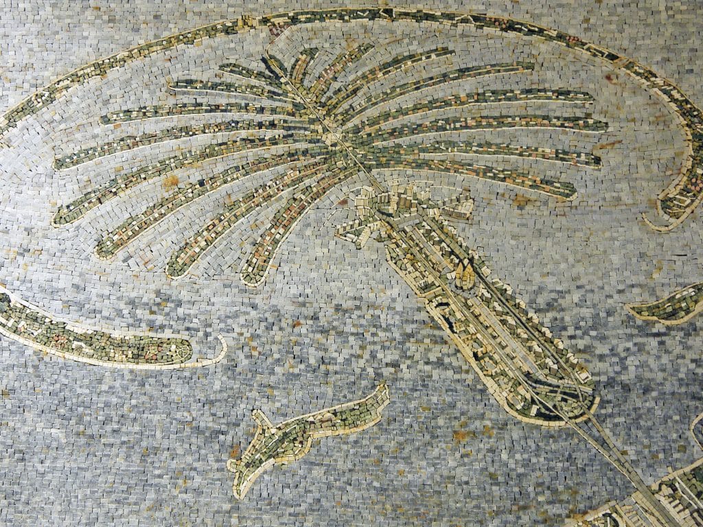 Mosaic of palm tree shape of islands - brown tiles on blue and grey background