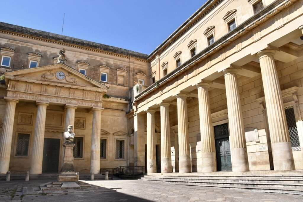 Courtyard with pillars to the right. Sandstone. Blue sky above