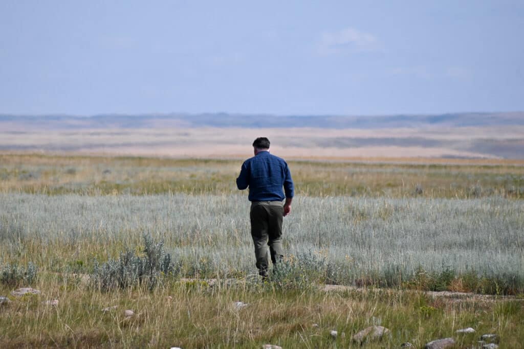 Man wearing walking trousers to protect from Ticks & Rattlesnakes, Grasslands National Park