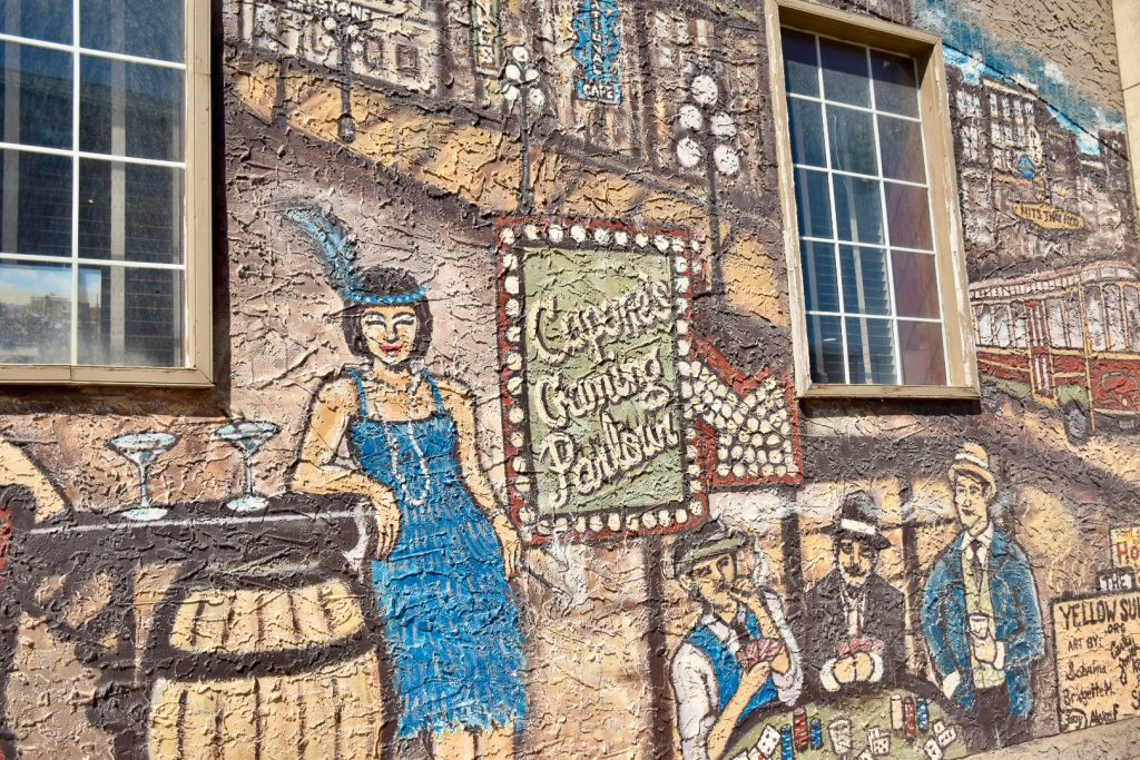 Mural filling a wall with scenes of bootlegging from 1930s