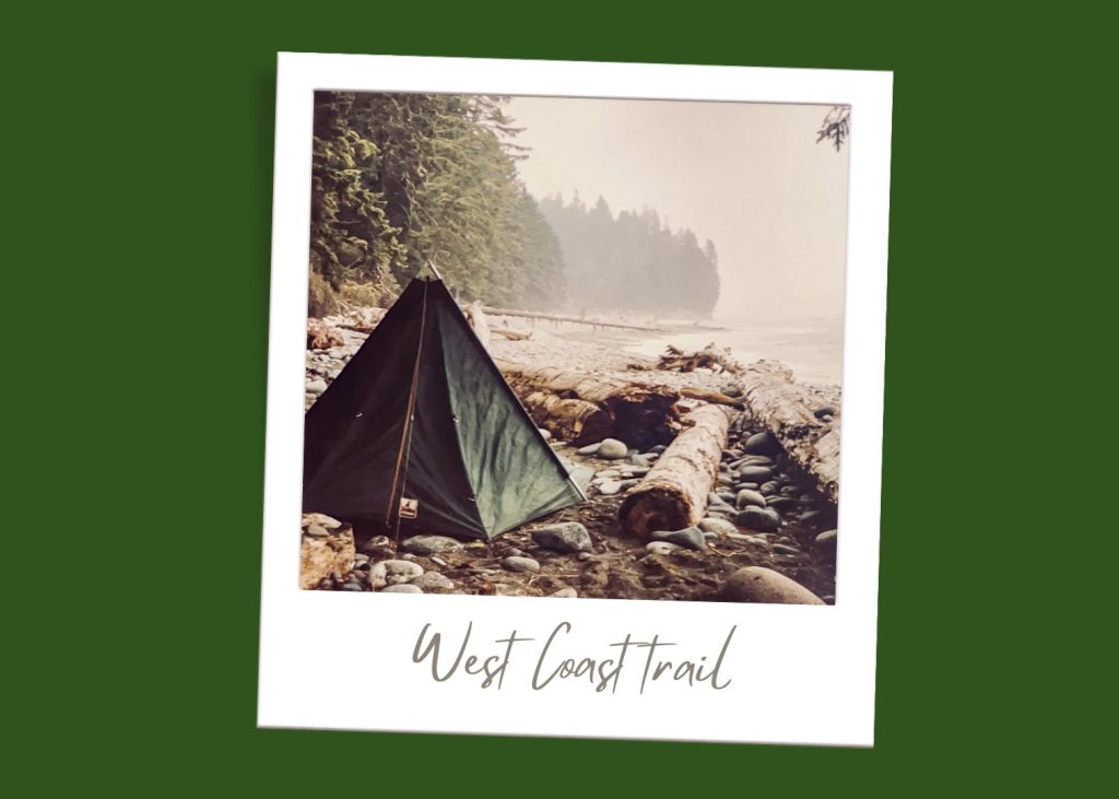 Forest green background. A polaroid photo sits in the middle of the frame. The photo on the polaroid is an old photo of a green triangular tent on a rocky beach, protected from the sea by large pieces of driftwood. Fir trees to the left. On the polaroid under the photo it says 'West Coast Trail'