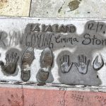 Stone in pavement featuring hand prints and shoe prints of Ryan Gosling (left) and Emma Stone (right). Parked as La La Land 12//7/16