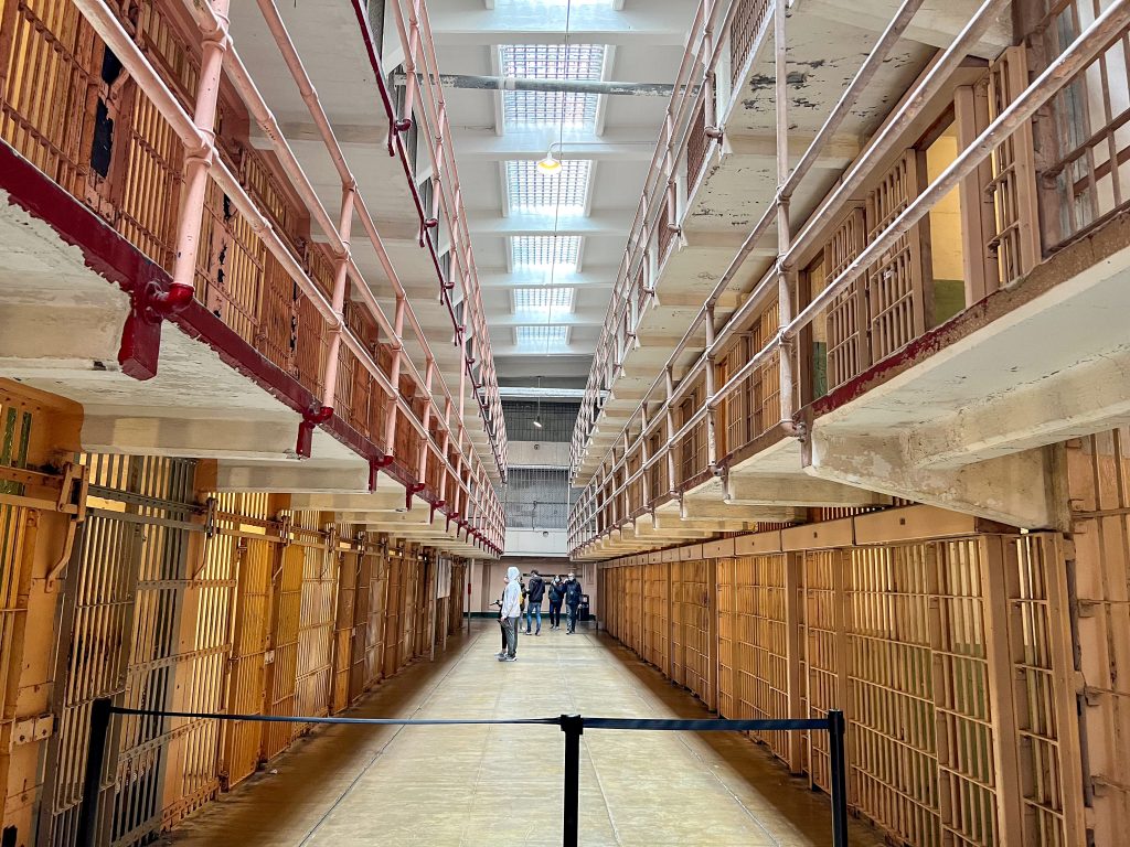 View down the centre of a double row of prison cells