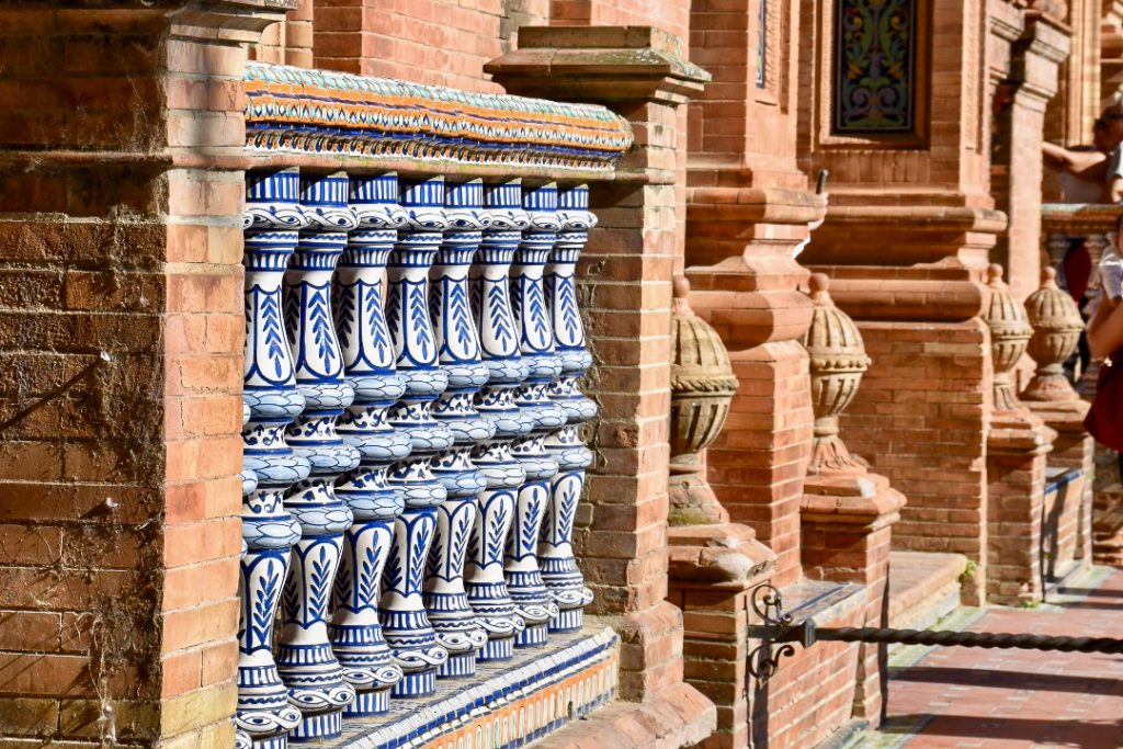 Red brick building with a row of tiled blue and white balustrades in the middle