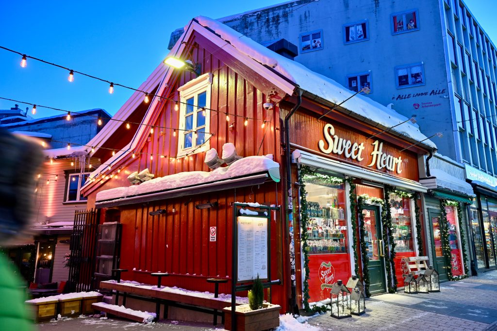 Red wooden shop in twilight. It says Sweet Heart over the door