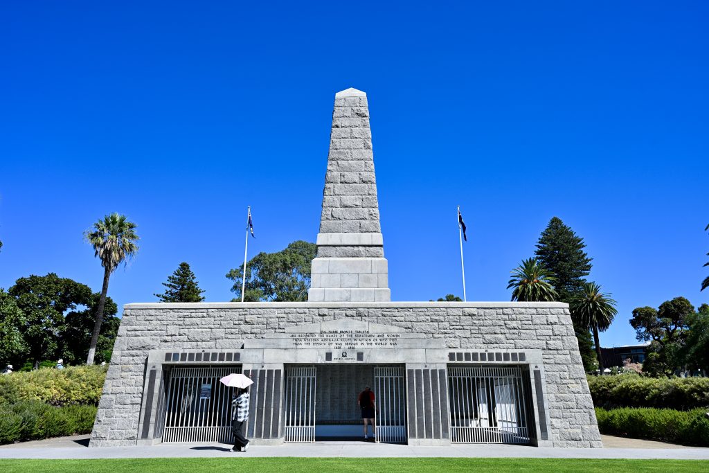 A stone obelisk stands on top of a platform with rooms beneath. Blue sky behind