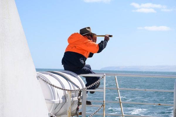 Man with spyglass solo travelling with nut allergy ferry to Kangaroo island Australia