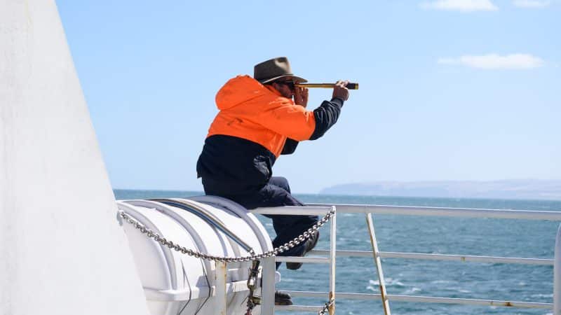 Man with spyglass solo travelling with nut allergy ferry to Kangaroo island Australia
