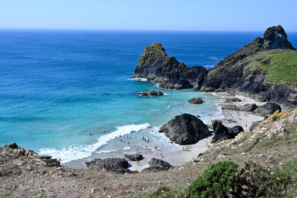 A gorgeous cove - sandy beach with rocks on the sand. Turquoise and blue sea.