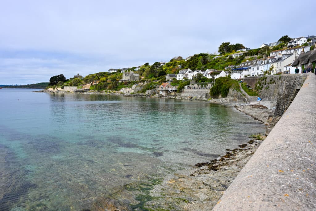 View of a small harbour village. Cluster of small cottages around a body of turquoise water.