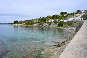 View of a small harbour village. Cluster of small cottages around a body of turquoise water.