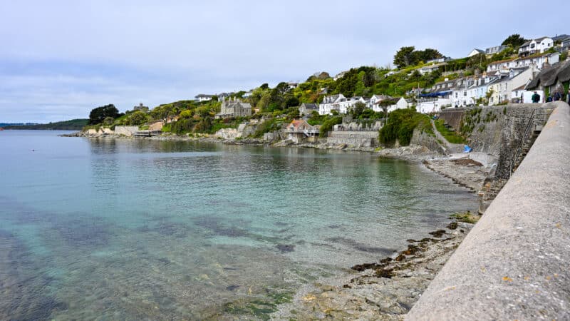 View of a small harbour village. Cluster of small cottages around a body of turquoise water.