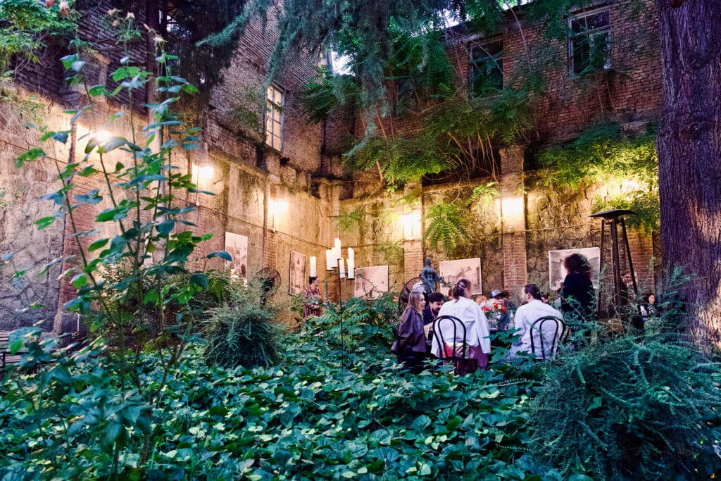 Outdoor garden restaurant. Party of diners around a circular table