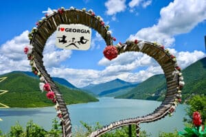 View of a reservoir surrounded by hills, taken through a wooden heart.