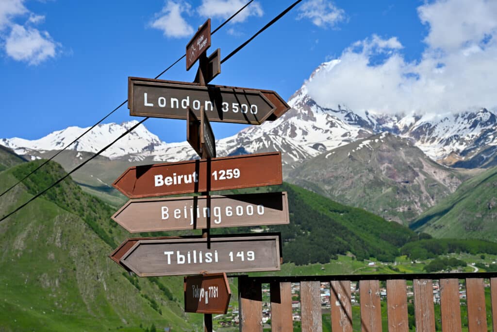 Signpost in the mountains - distances to London, Beirut, Beijing and Tbilisi