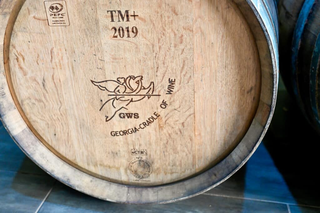 The side of a wooden barrel of wine. It says 'Georgia - Cradle of Wine' on it.
