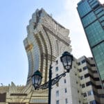Tall modern glass building shaped like a lotus flower