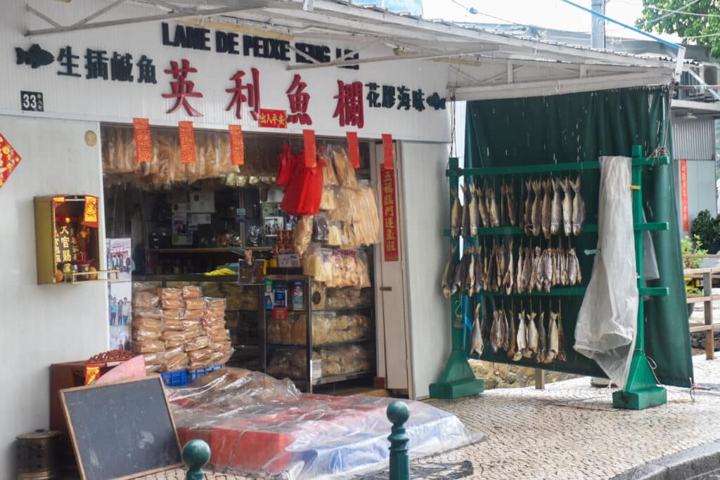 Chinese shop selling fish which are handing in rows to the rights