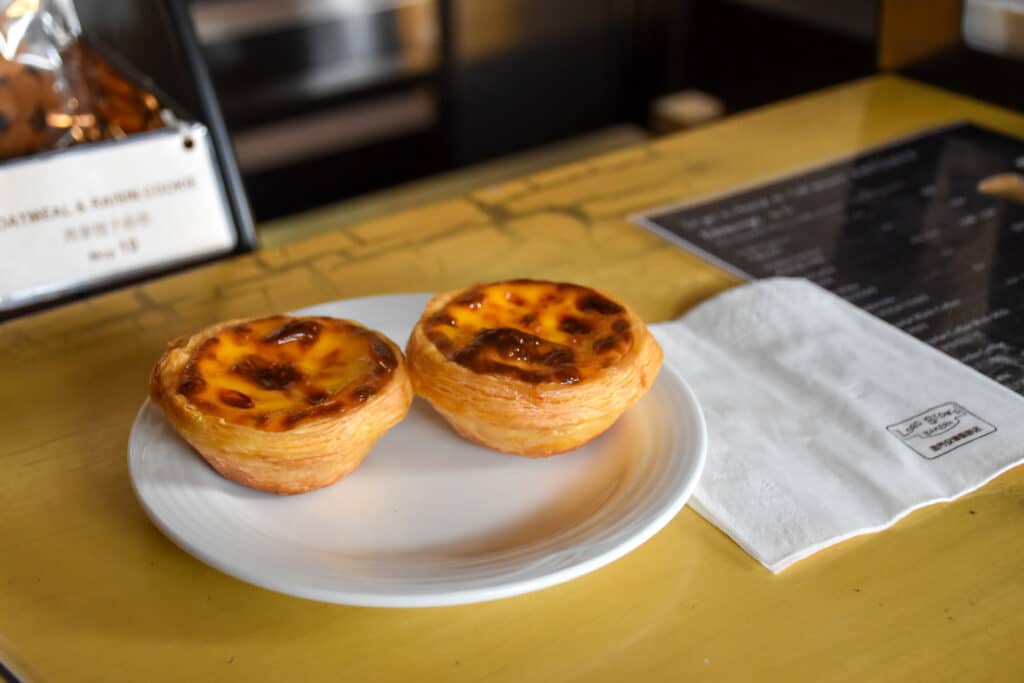 Two egg custard tarts on a white plate