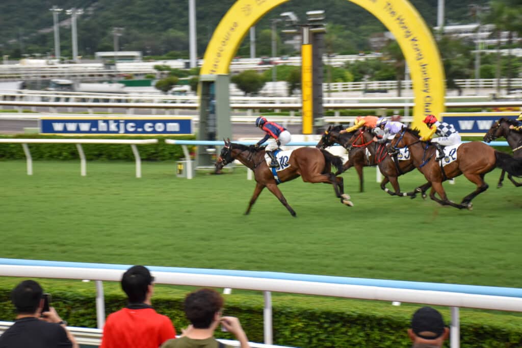 Horse racing - horses riding past finish post