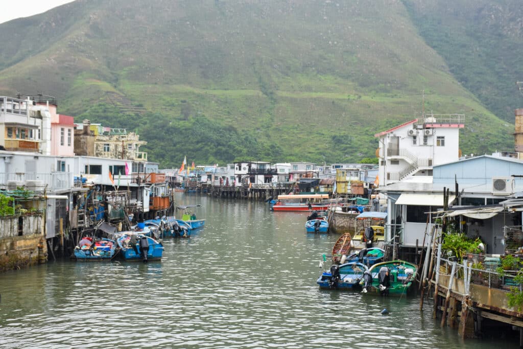 Looking down a water channel with stilted buildings on either side