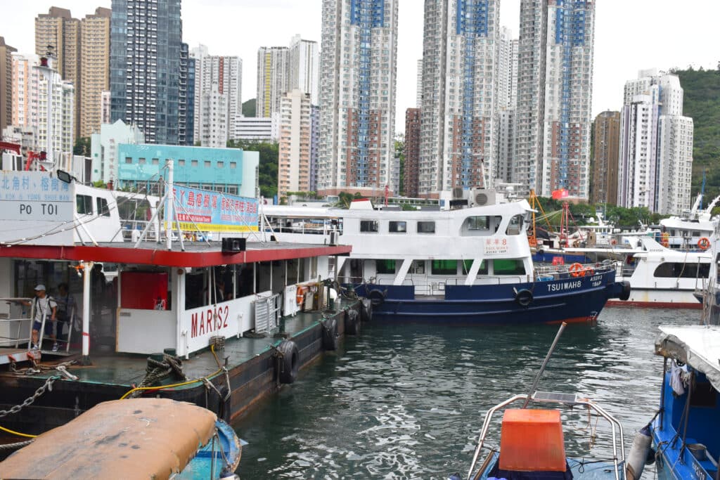 Harbour views - boats in foreground. Blocks of flats behind