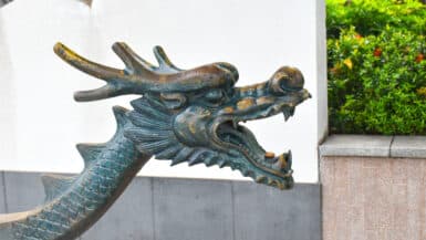 A metal dragon head with mouth open faces to the right