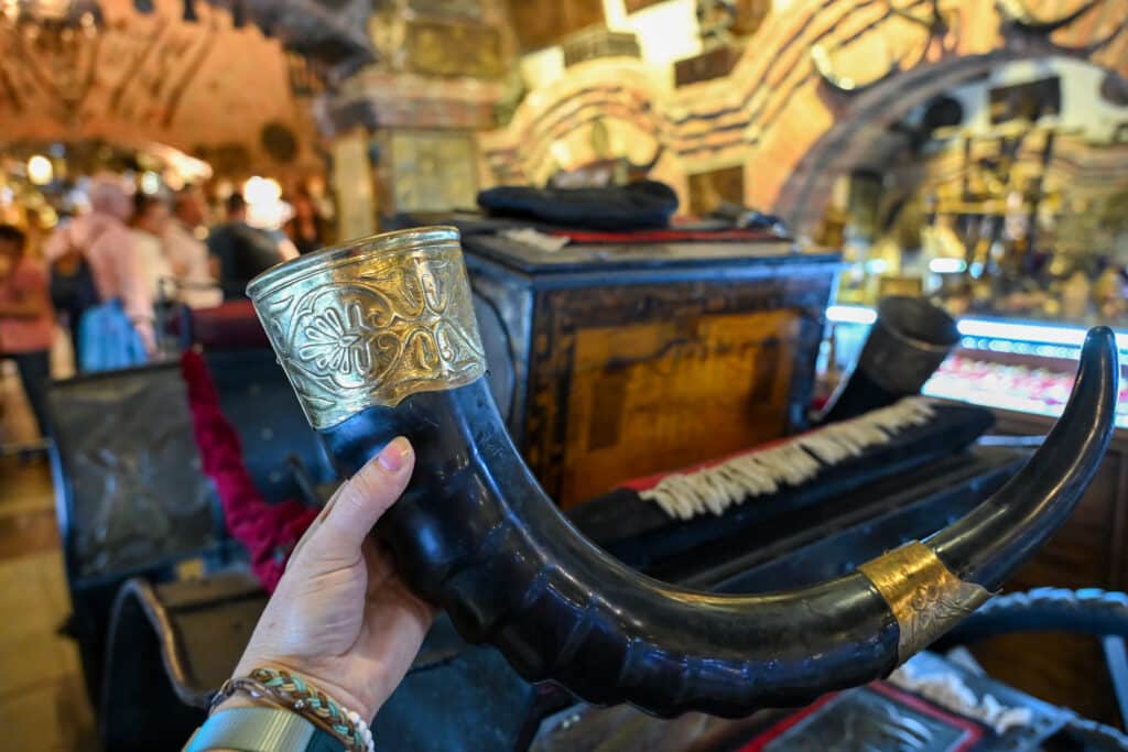 A hand holding up a toasting horn in market