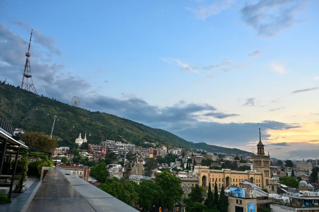 Sun down on a city with hill in background