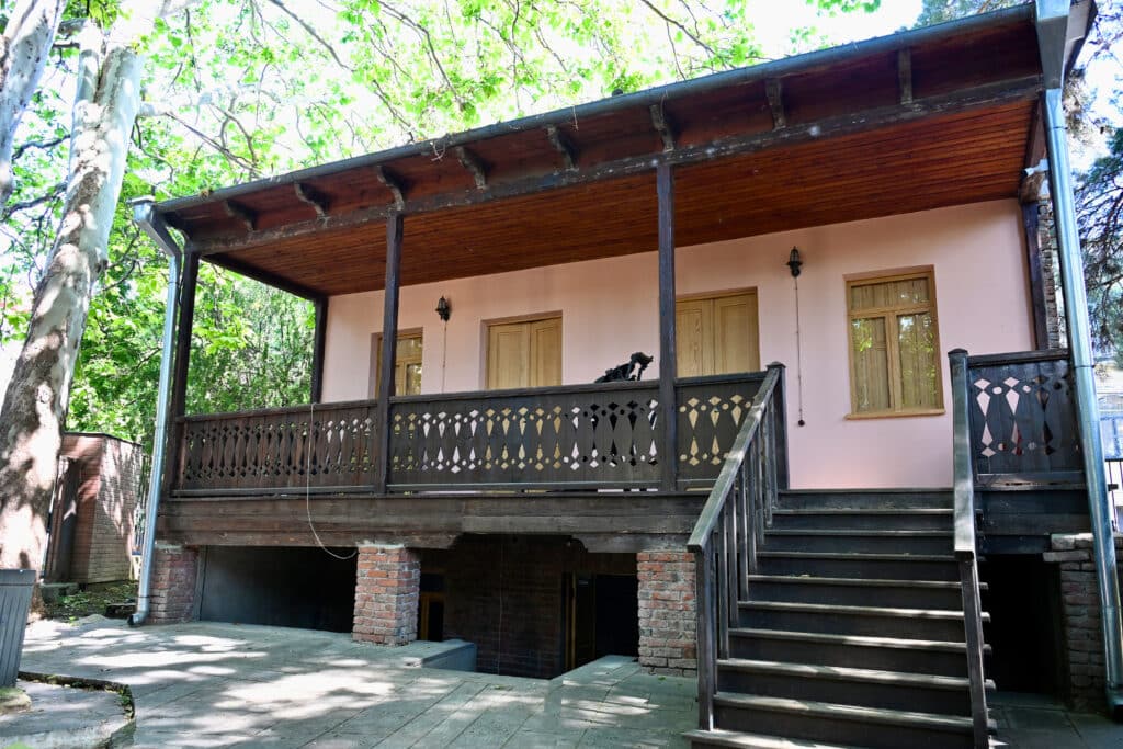 Pink house with wooden balcony