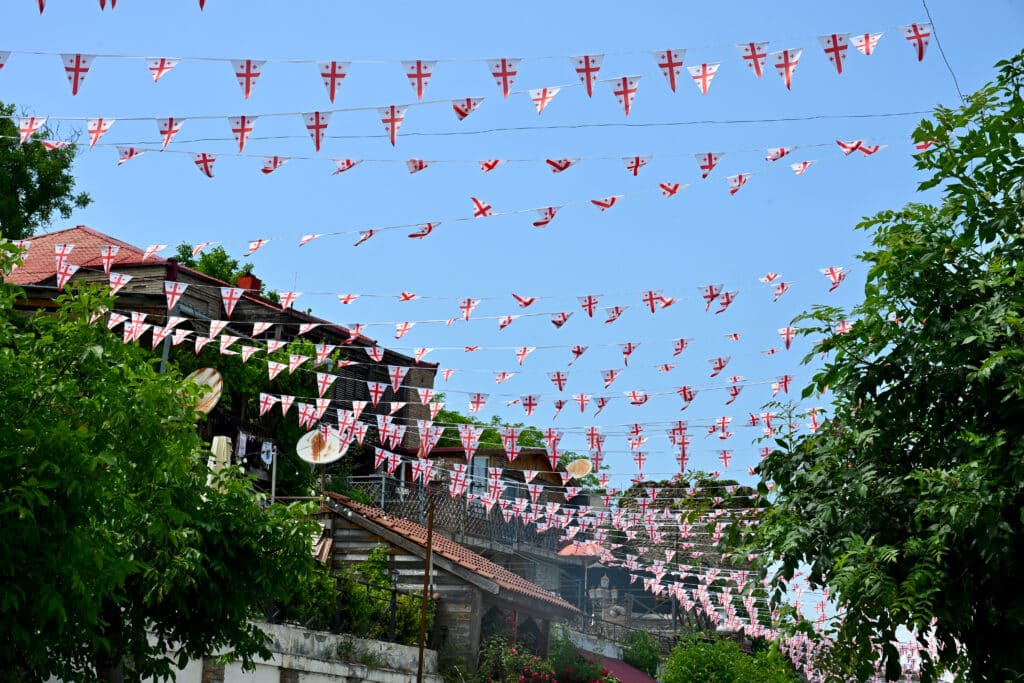 Rows of white and red flags across road