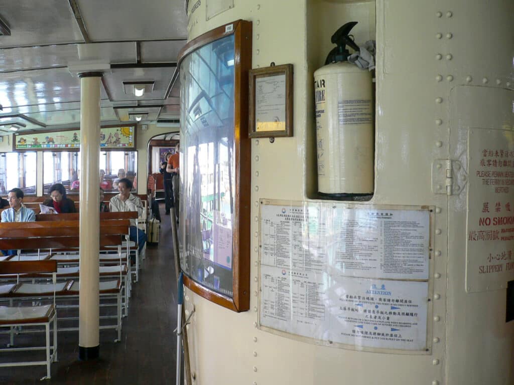On board the inside deck of a ferry - seats to the left. Cream pillar to the right