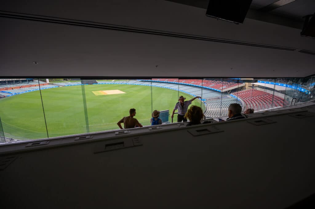 Adelaide Oval Tour group and guide viewing the oval from the Media Centre