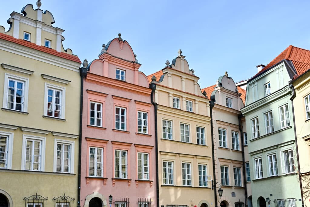 Row of pastel coloured town houses with gable roofs