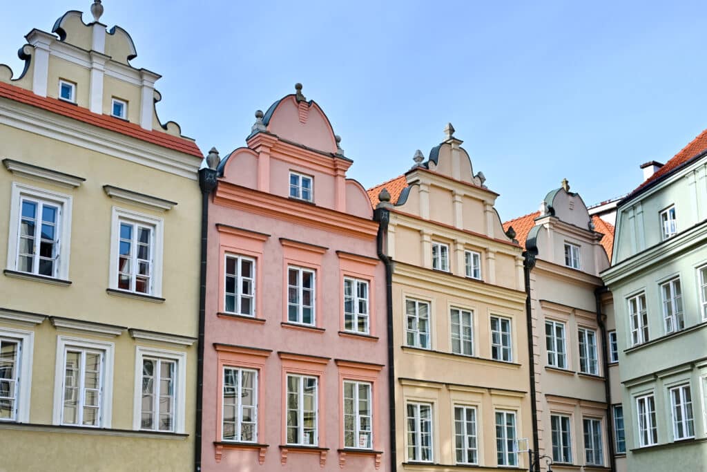Row of pastel coloured town houses with gable roofs