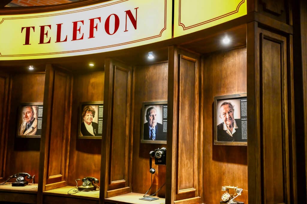 Telephone box with 4 wooden booths which appear to feature a different person to call