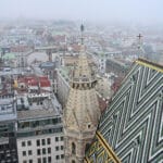 View over the tiled roof of a church with Old Town buildings below