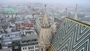 View over the tiled roof of a church with Old Town buildings below