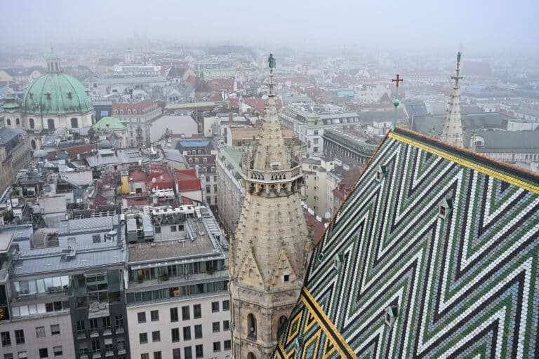 View over the tiled roof of a church with Old Town buildings below