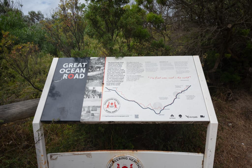 Great Ocean Road engineering heritage board displaying a coastal route map, historic photographs and construction history.