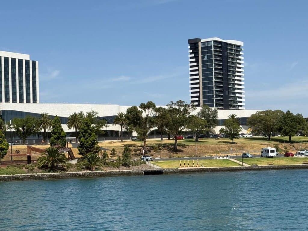 Nyaal Banyul’s pale waterfront façade and nearby high-rise buildings overlook Western Beach and Corio Bay in Geelong.