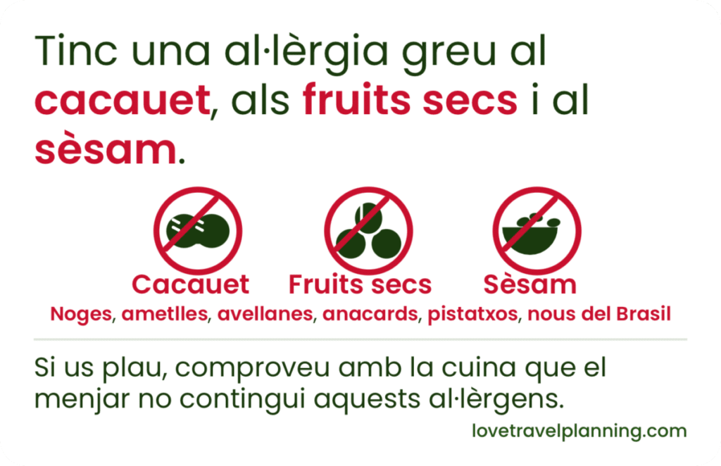 Catalan nut allergy card stating a severe allergy to peanuts (cacauet), tree nuts (fruits secs) and sesame (sèsam), with three crossed-out icons and a request to check with the kitchen.