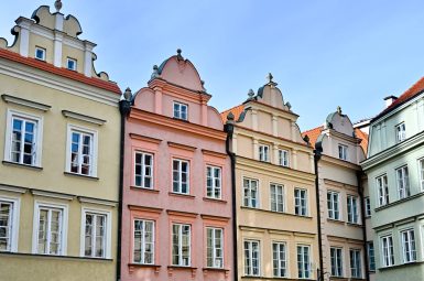 Row of pastel coloured town houses with gable roofs